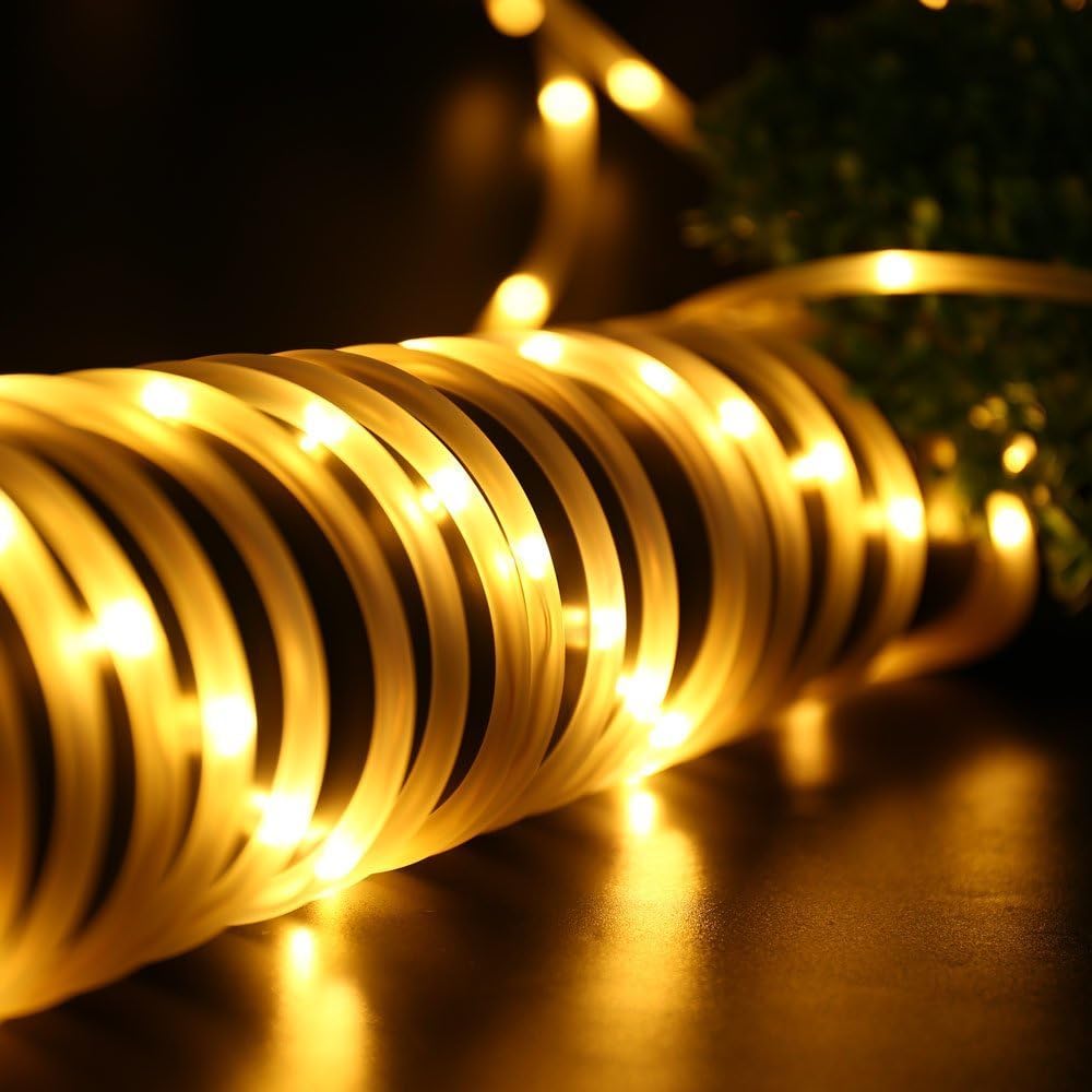 Coiled string of lights on a reflective surface at night