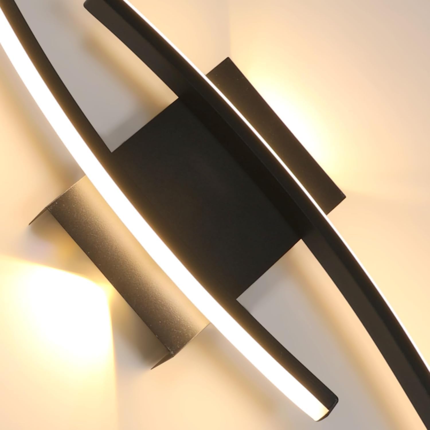 Modern wall-mounted light fixture with black finish on a neutral background