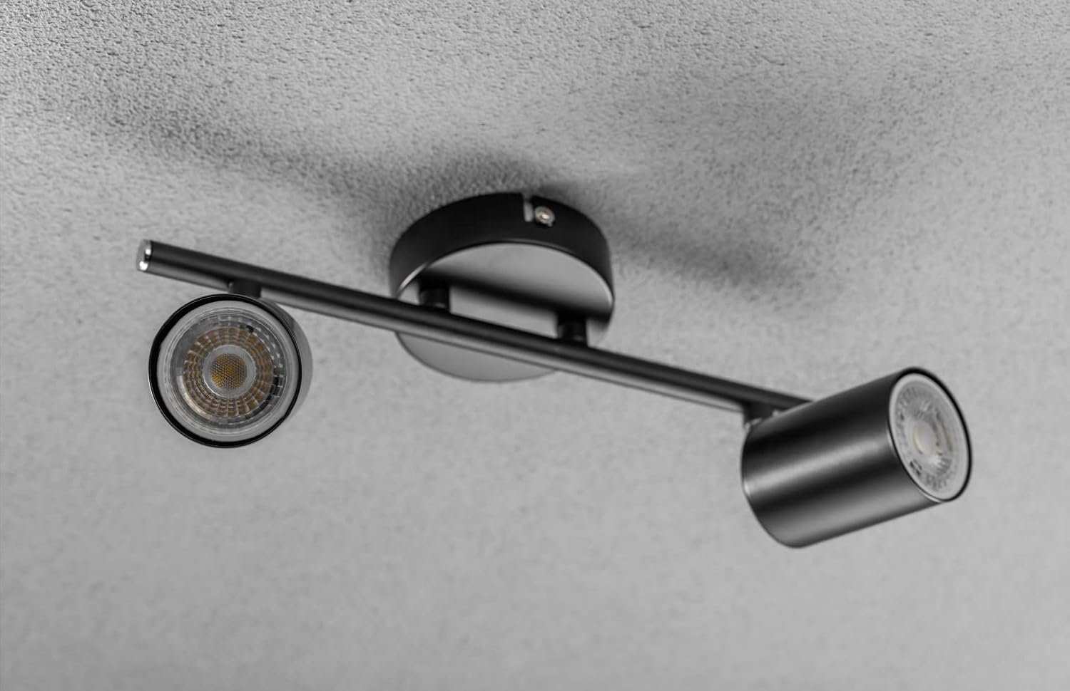 Modern ceiling light fixture with two cylindrical lights on a gray background