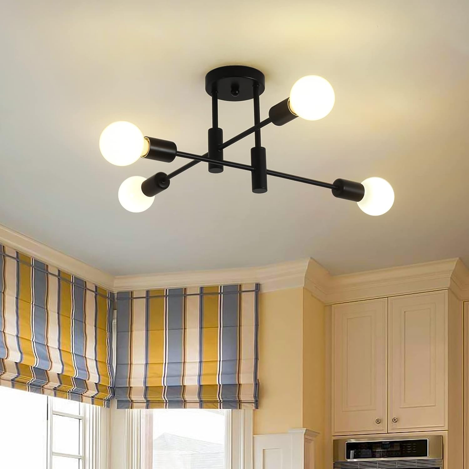 Modern ceiling light fixture in a kitchen with striped window valance.