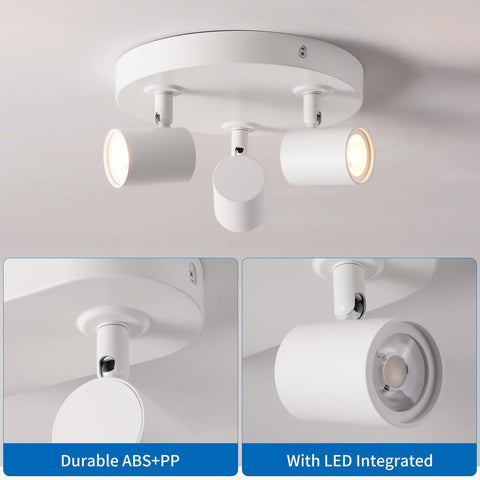 White ceiling light fixture with three adjustable lights on a gray background