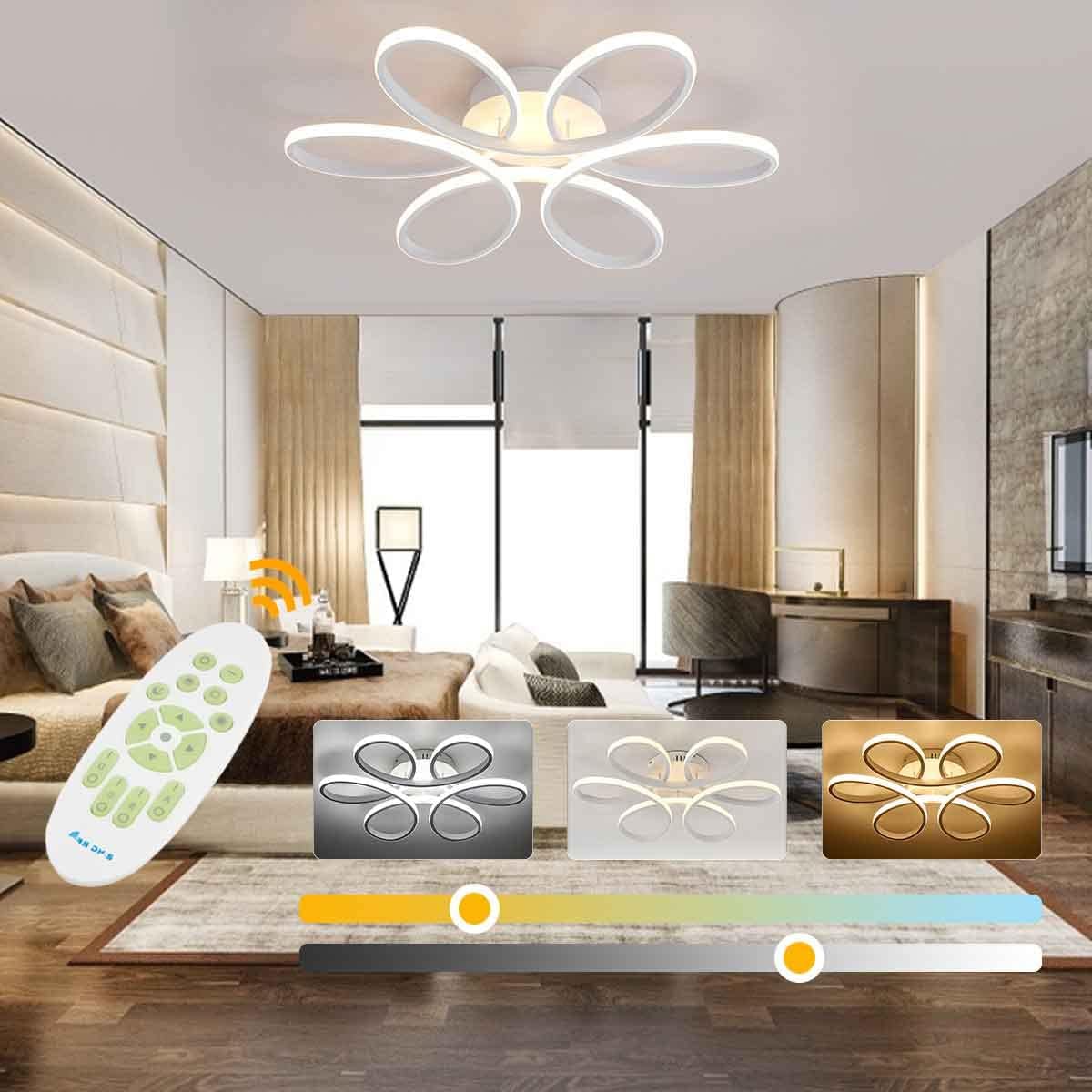 Modern bedroom with ceiling light fixture, remote control, and decorative items.