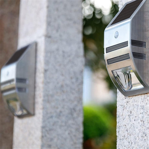 Motion-activated LED fence light detecting movement in a garden

