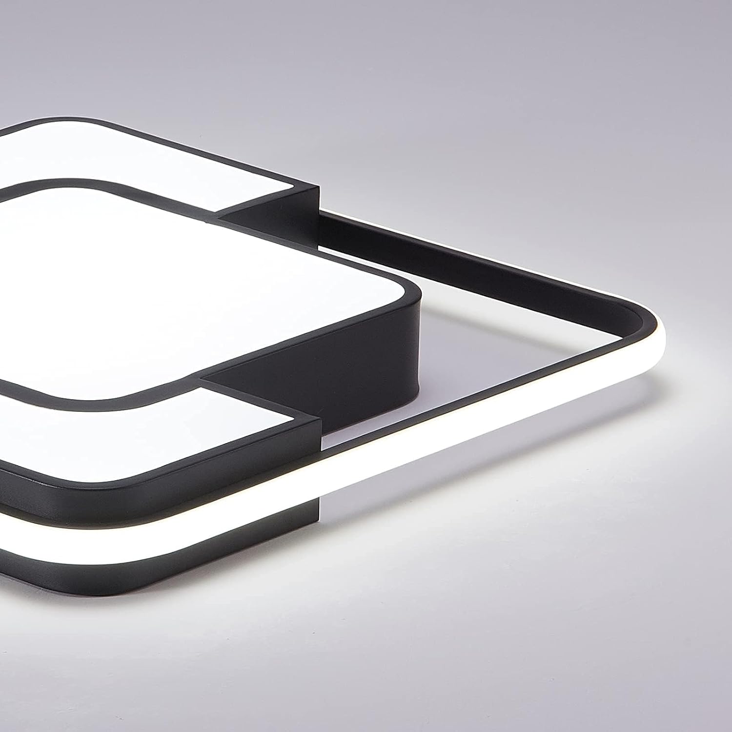 Modern black and white light fixture on a gray background