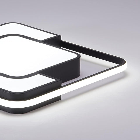 Modern black and white light fixture on a gray background