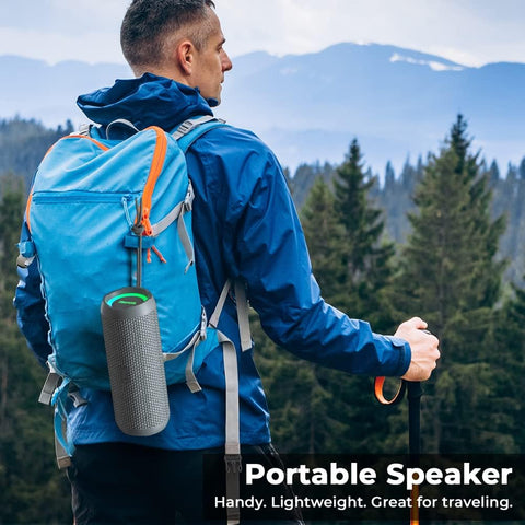 Man with blue backpack and portable speaker in a forest setting