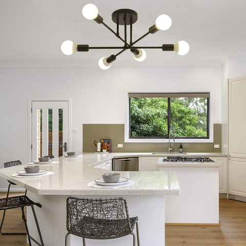 Modern kitchen with a chandelier, island, and chairs.