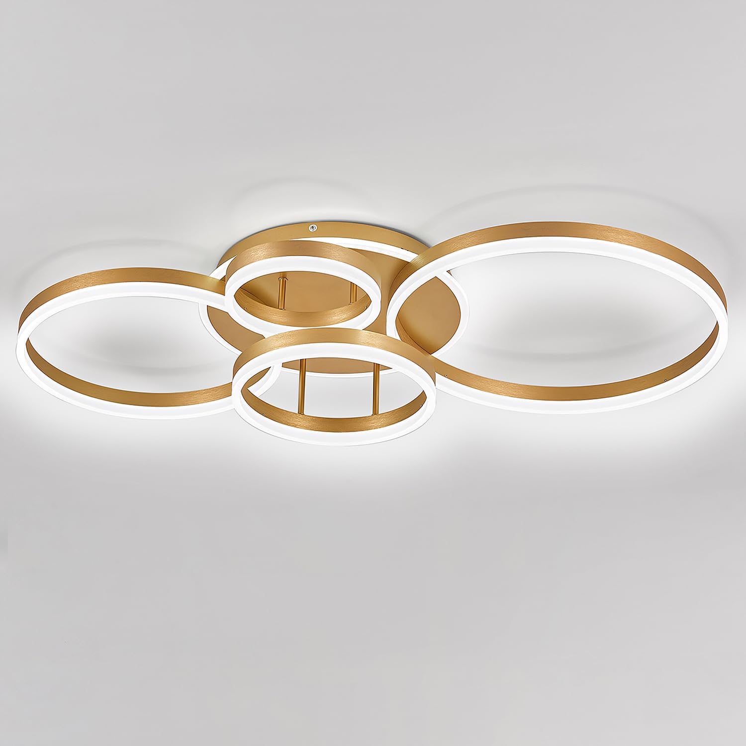 Modern ceiling light fixture with gold and white design on a gray background