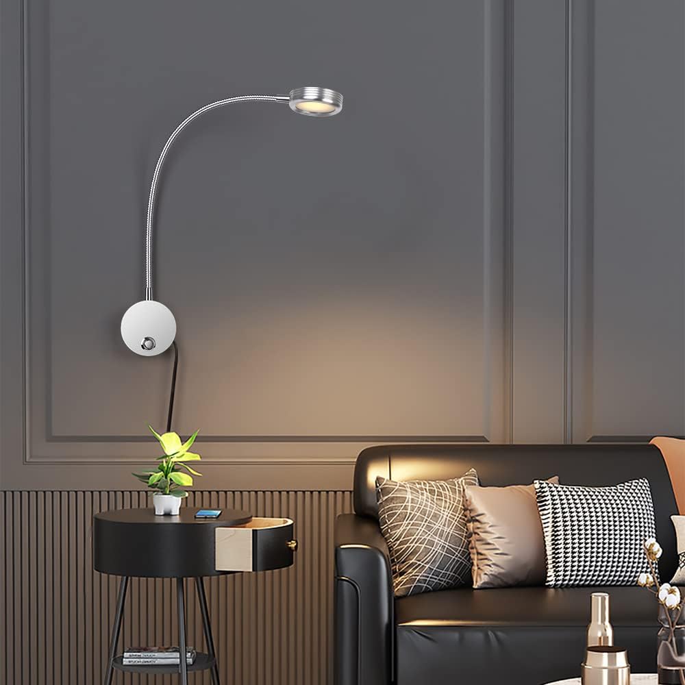 Modern living room with a black sofa, side table, and wall-mounted lamp.