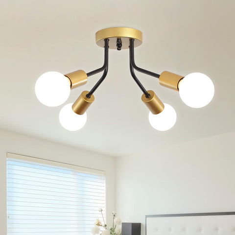 Modern ceiling light fixture with gold and black design in a room setting.