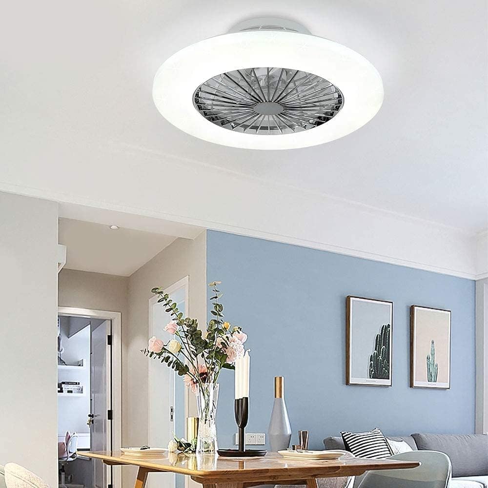 Ceiling light fixture in a modern living room with a table and decor items.