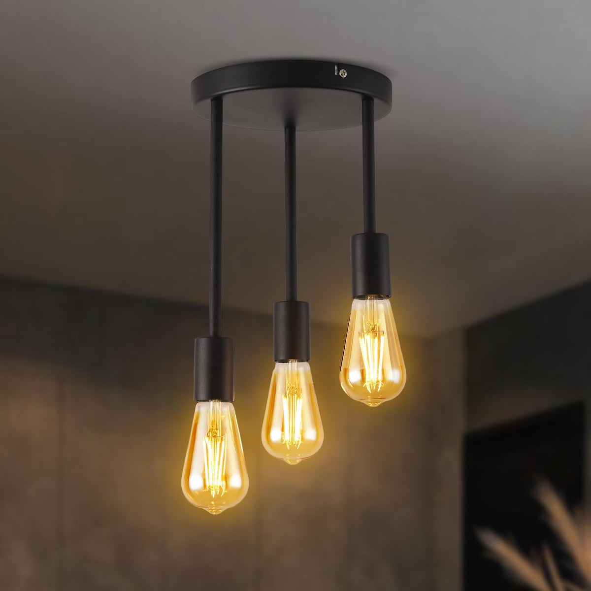 Ceiling light fixture with three lit bulbs on a neutral background