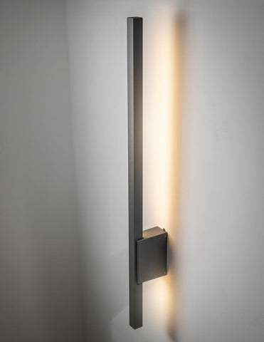 Modern wall-mounted light fixture on a gray wall