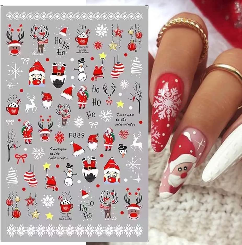 Christmas-themed nail art stickers with Santa Claus, reindeer, and snowflakes on a gray background, paired with a hand showing red and white nail designs.