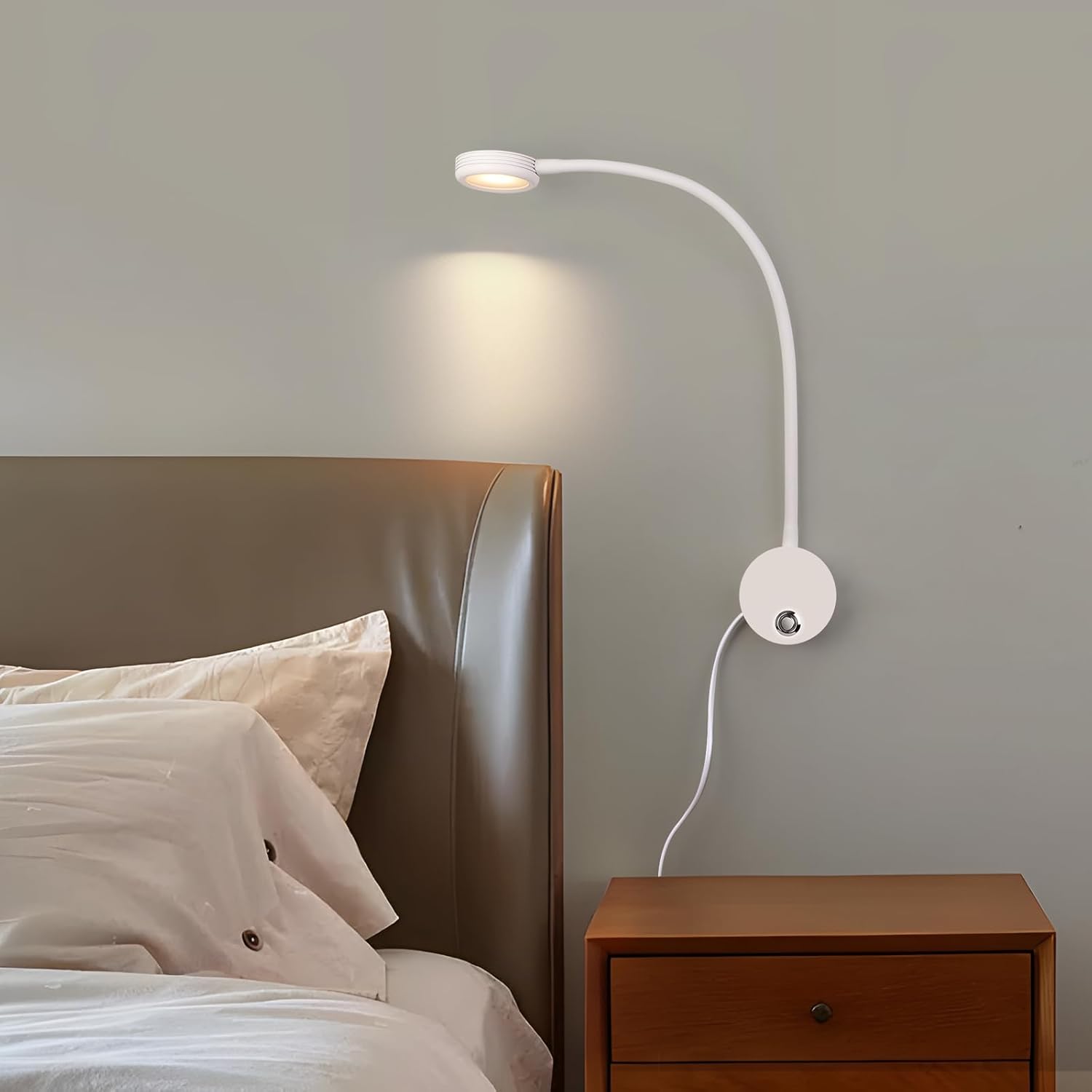 Wall-mounted reading lamp next to a bed with wooden nightstand