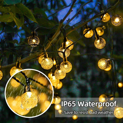 String lights with IP65 waterproof feature hanging on a tree branch.
