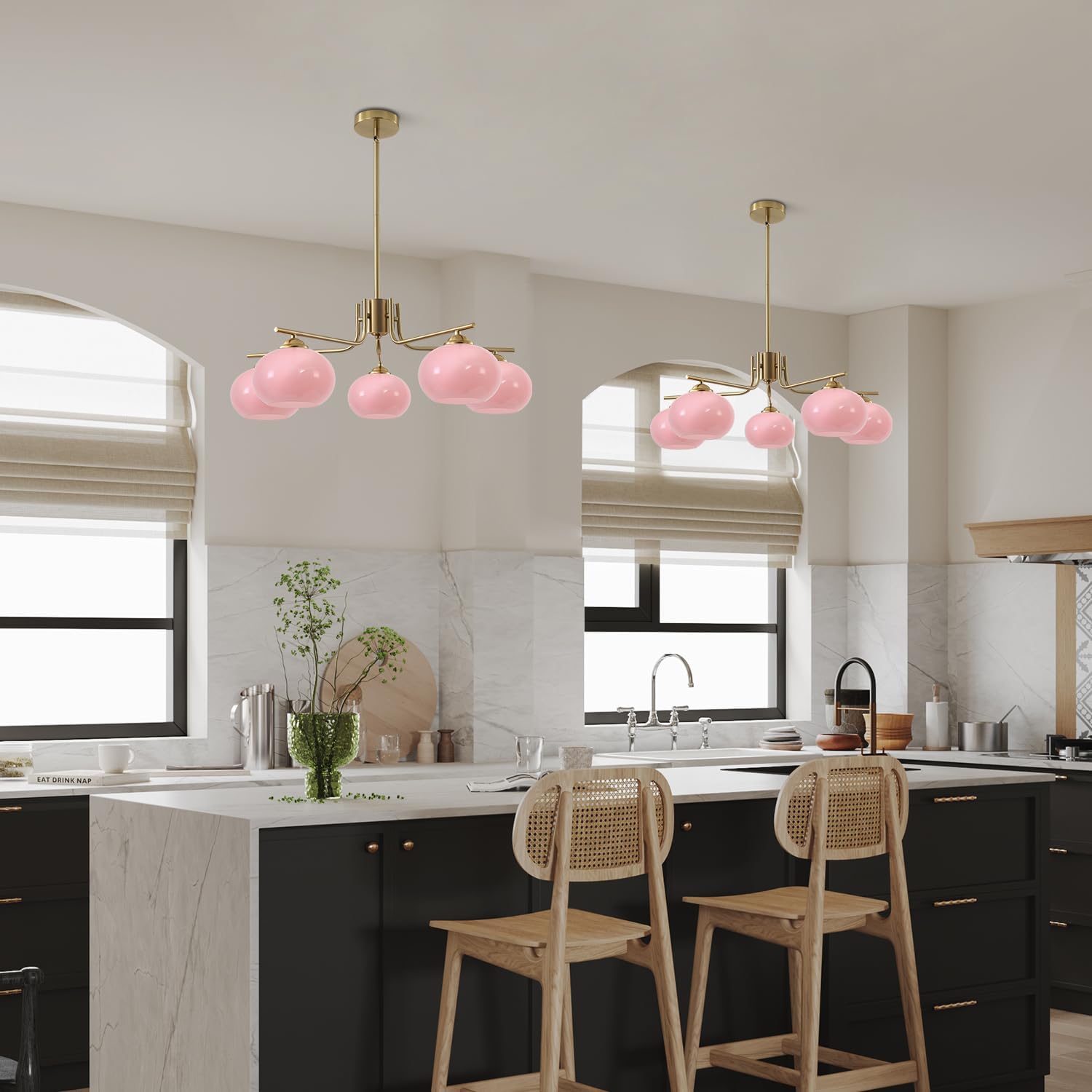 Modern kitchen with pink pendant lights and wooden stools.