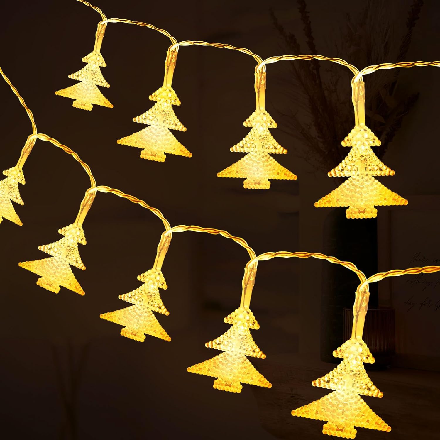 String of Christmas tree-shaped lights on a dark background
