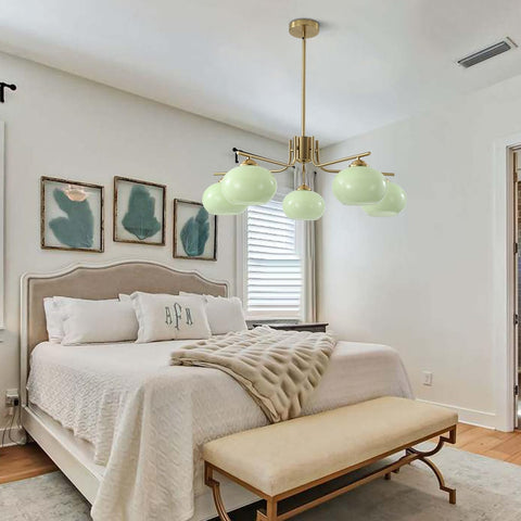 Modern bedroom with a chandelier, bed, and bench.