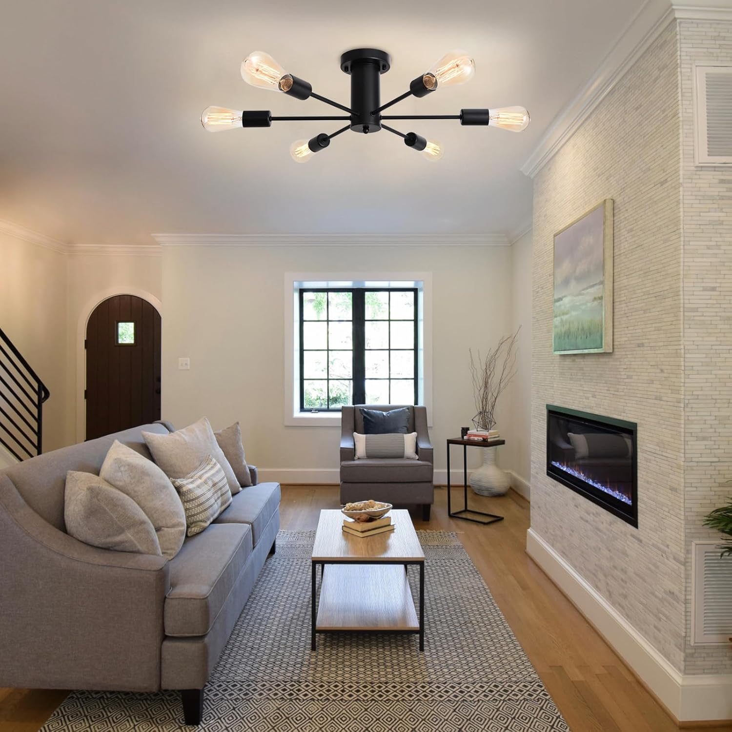 Modern living room with gray sofa, coffee table, and ceiling light fixture.