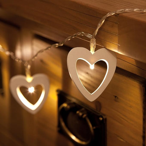 Heart-shaped fairy lights wrapped around a staircase railing.

