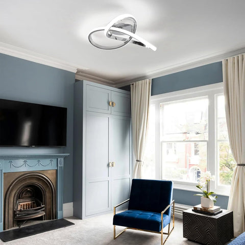 Modern living room with blue armchair, fireplace, and large window.