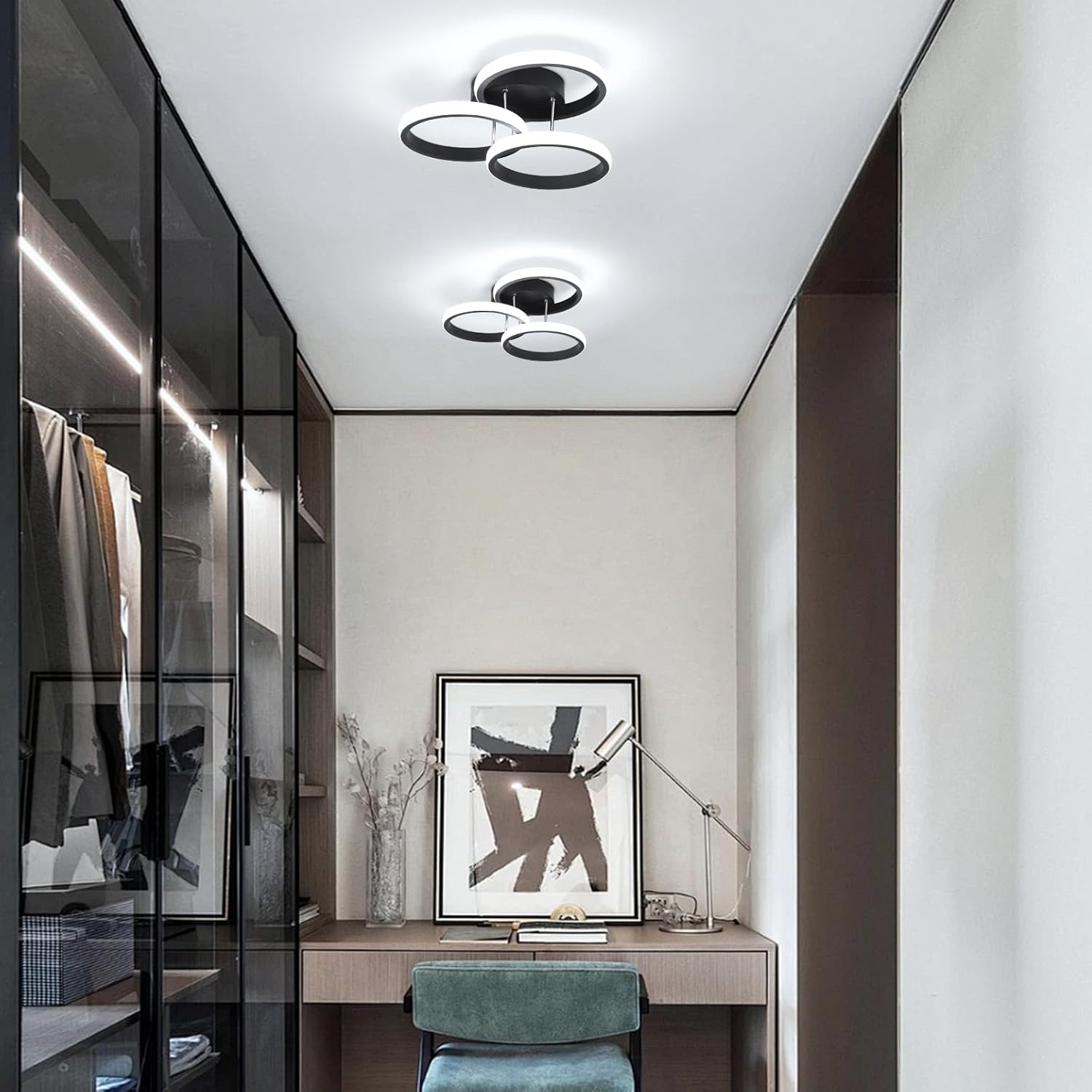 Modern interior of a room with a desk, chair, and wall art.