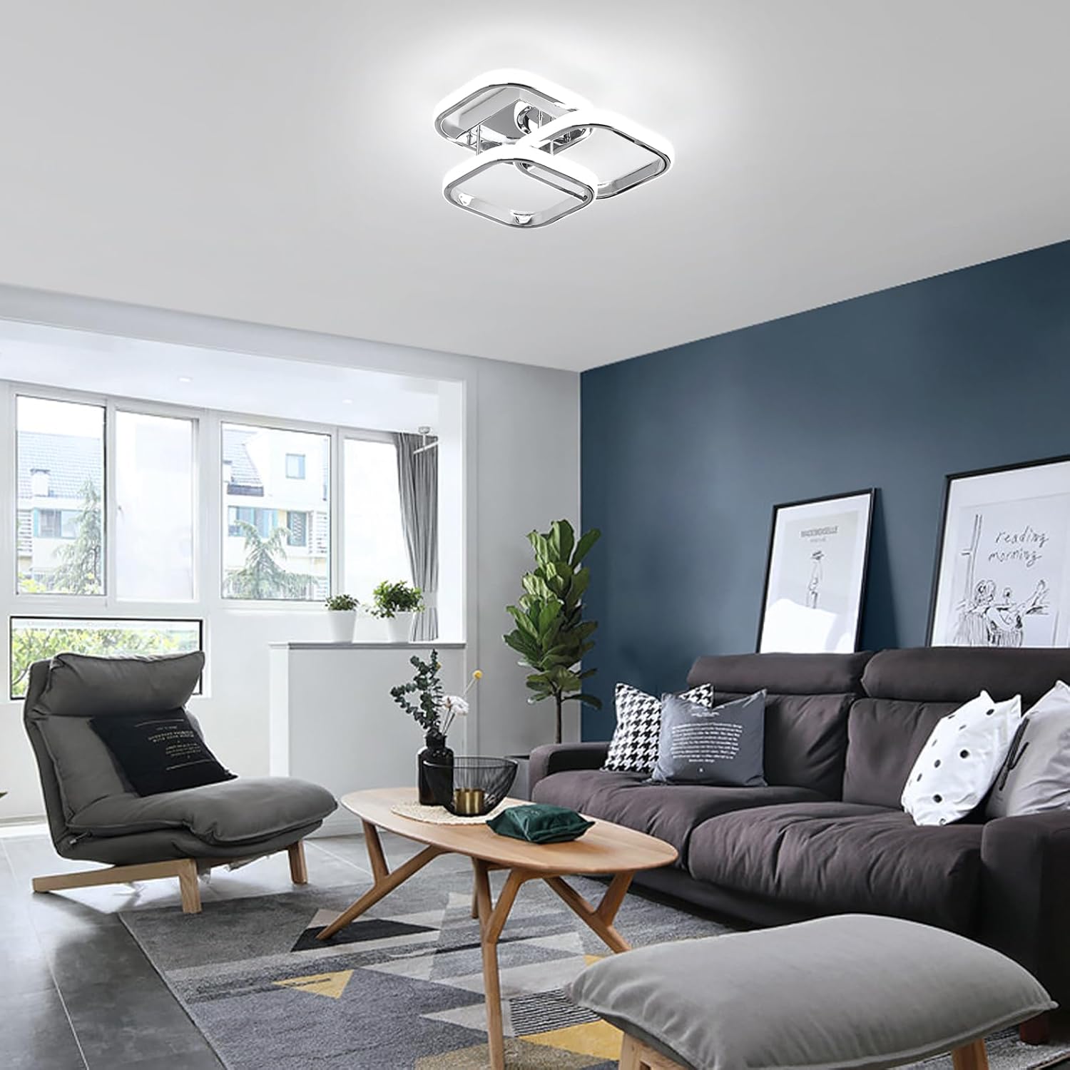 Modern living room with gray sofa, armchair, and ceiling light fixture.