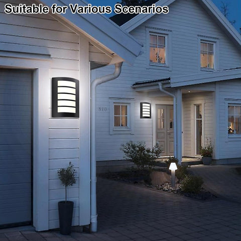 Modern house exterior with wall-mounted lights and a well-lit pathway.