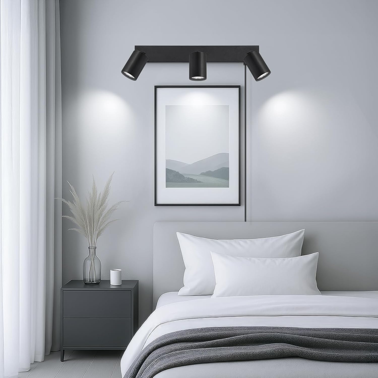 Modern bedroom with black wall lights, framed artwork, and a bed.