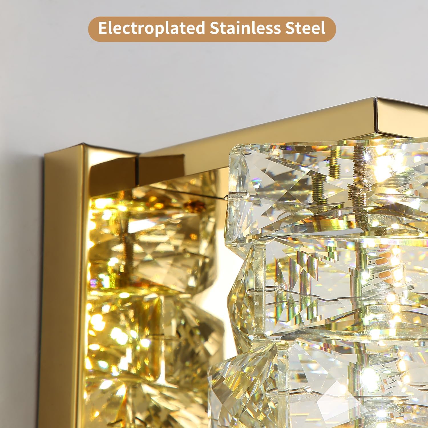 Gold and crystal wall light fixture with 'Electroplated Stainless Steel' text.