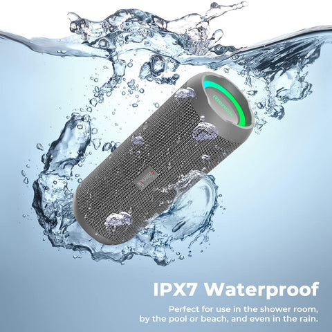 Waterproof Bluetooth speaker with water splashes around it on a blue background
