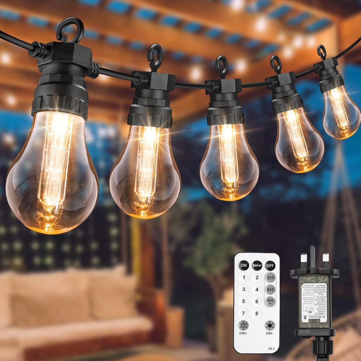 String of vintage-style light bulbs with a remote control and transformer on an outdoor setting.
