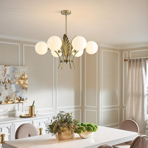 Modern chandelier in a dining room with a table and decor.