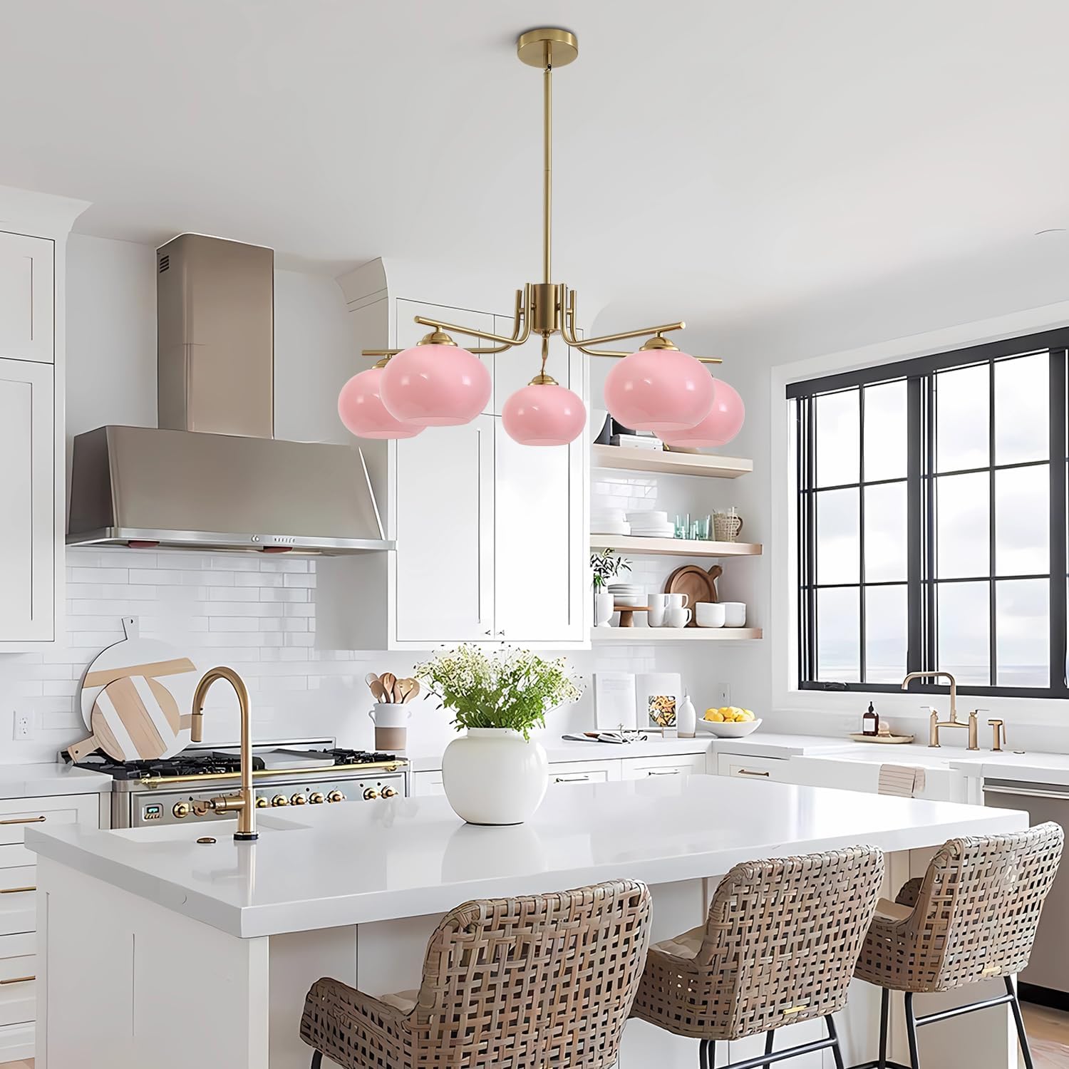 Modern kitchen with pink pendant light, white countertops, and wicker chairs.