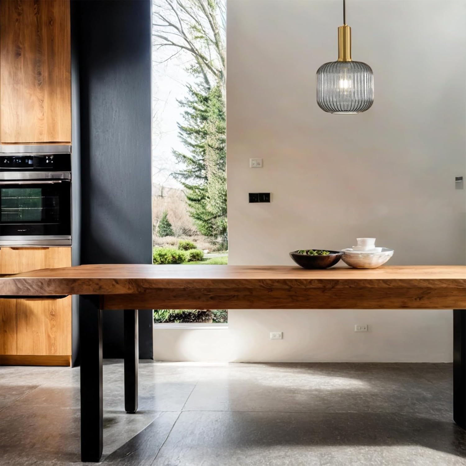 Modern kitchen with wooden dining table and pendant light