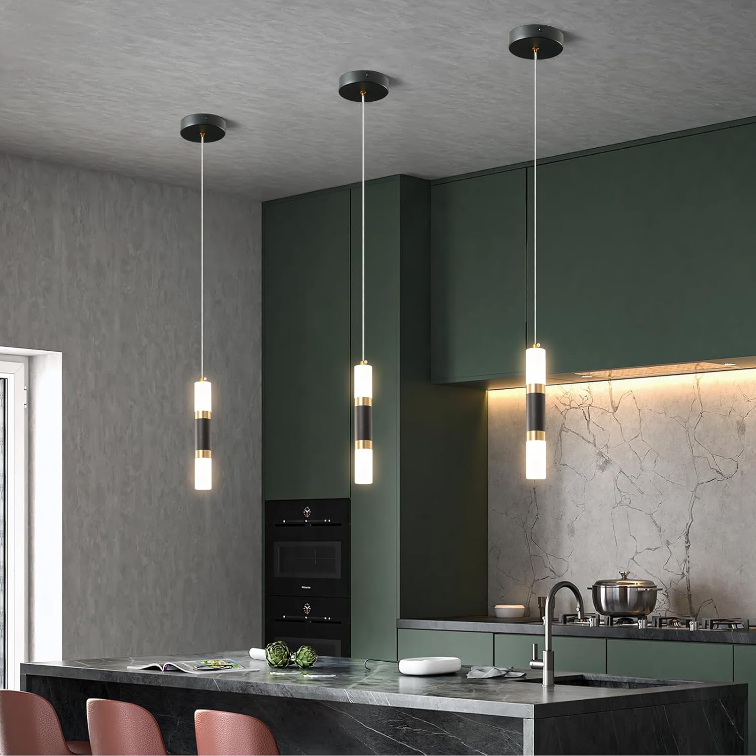Modern kitchen with pendant lights, green cabinets, and a marble backsplash.