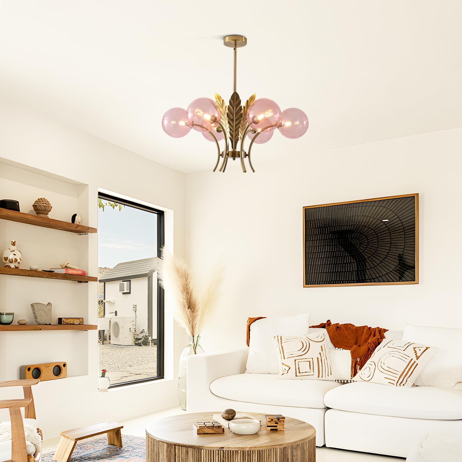Modern living room with a chandelier, sofa, and wall art.