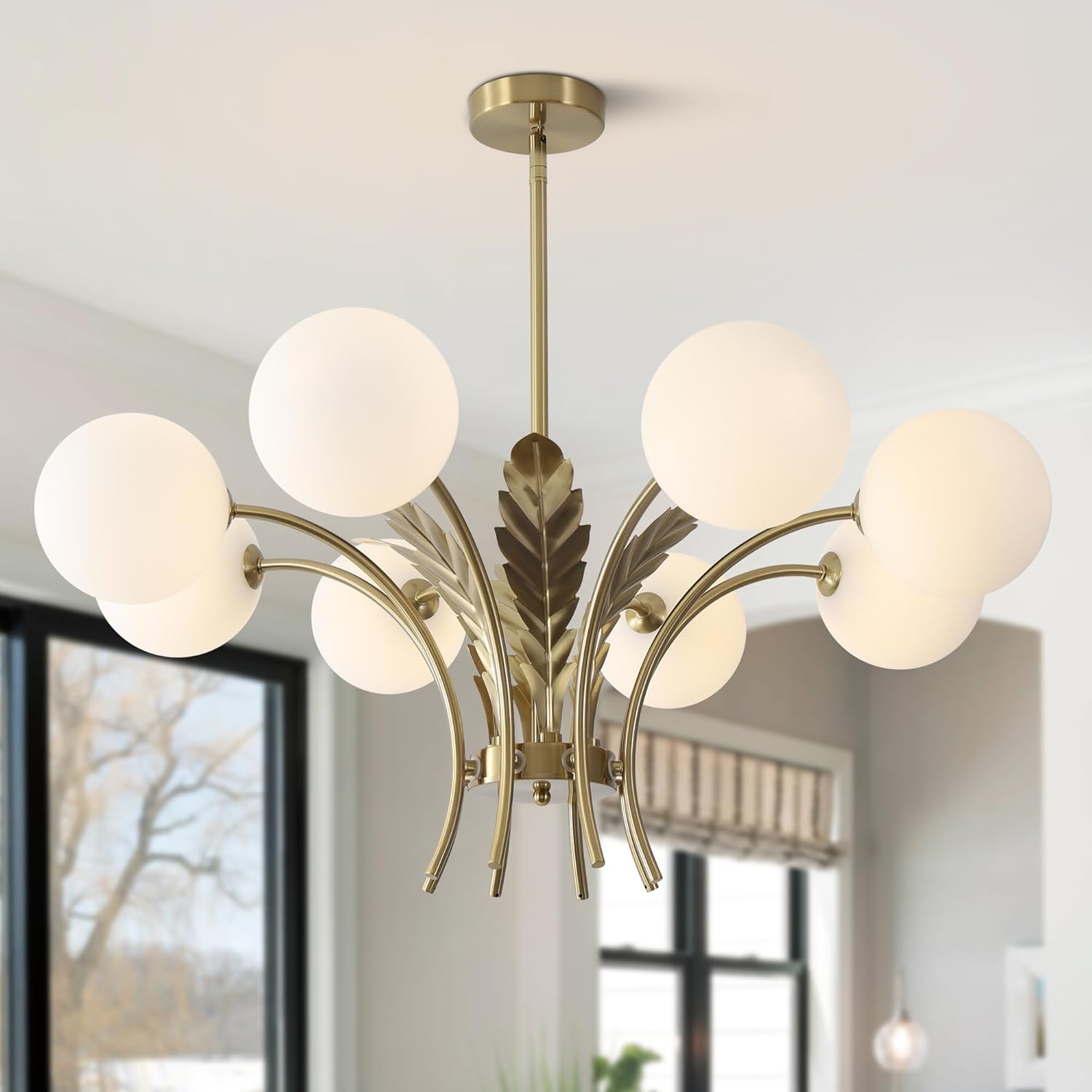 Modern chandelier with gold finish and white glass shades in a room setting.