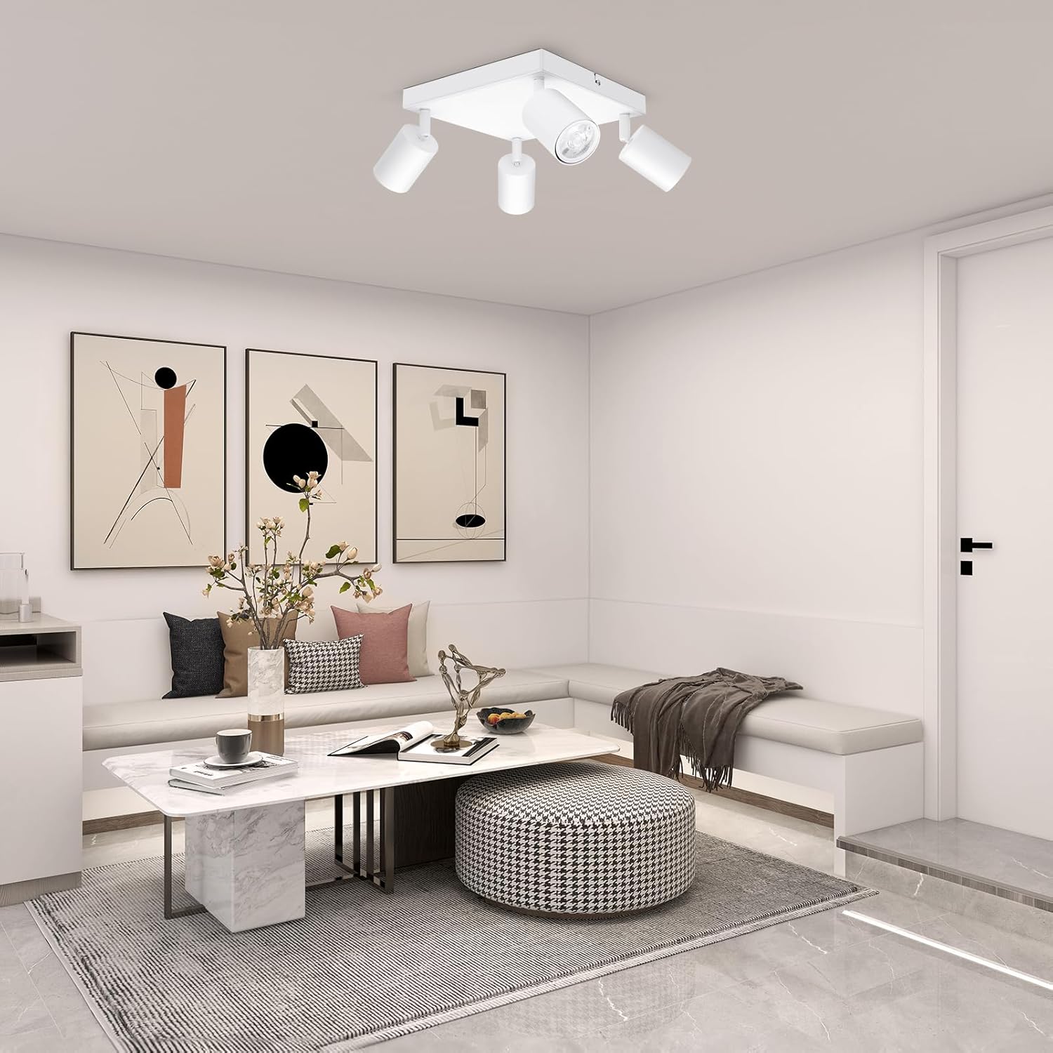 Modern living room with a ceiling light fixture, sofa, coffee table, and decorative items.