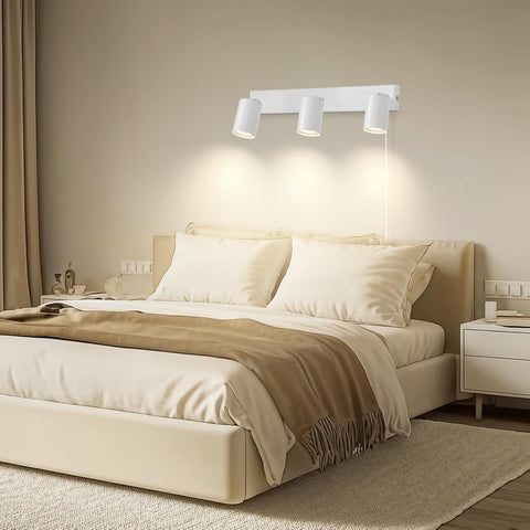 Modern bedroom with beige bed, wall lights, and nightstands.