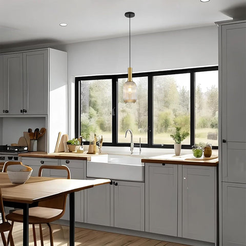 Modern kitchen with gray cabinets, wooden countertops, and a large window.