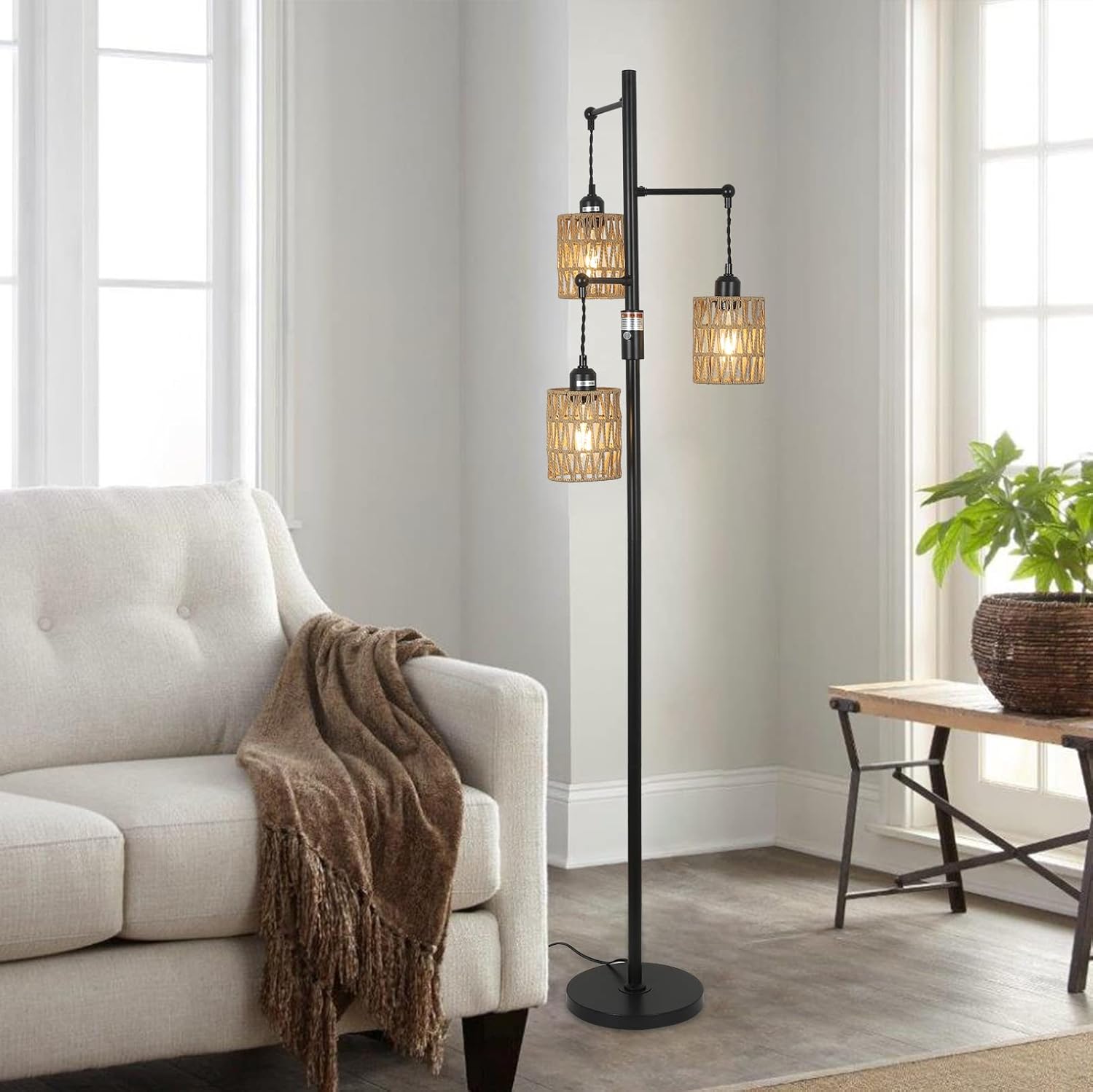 Floor lamp with multiple lampshades in a living room setting.