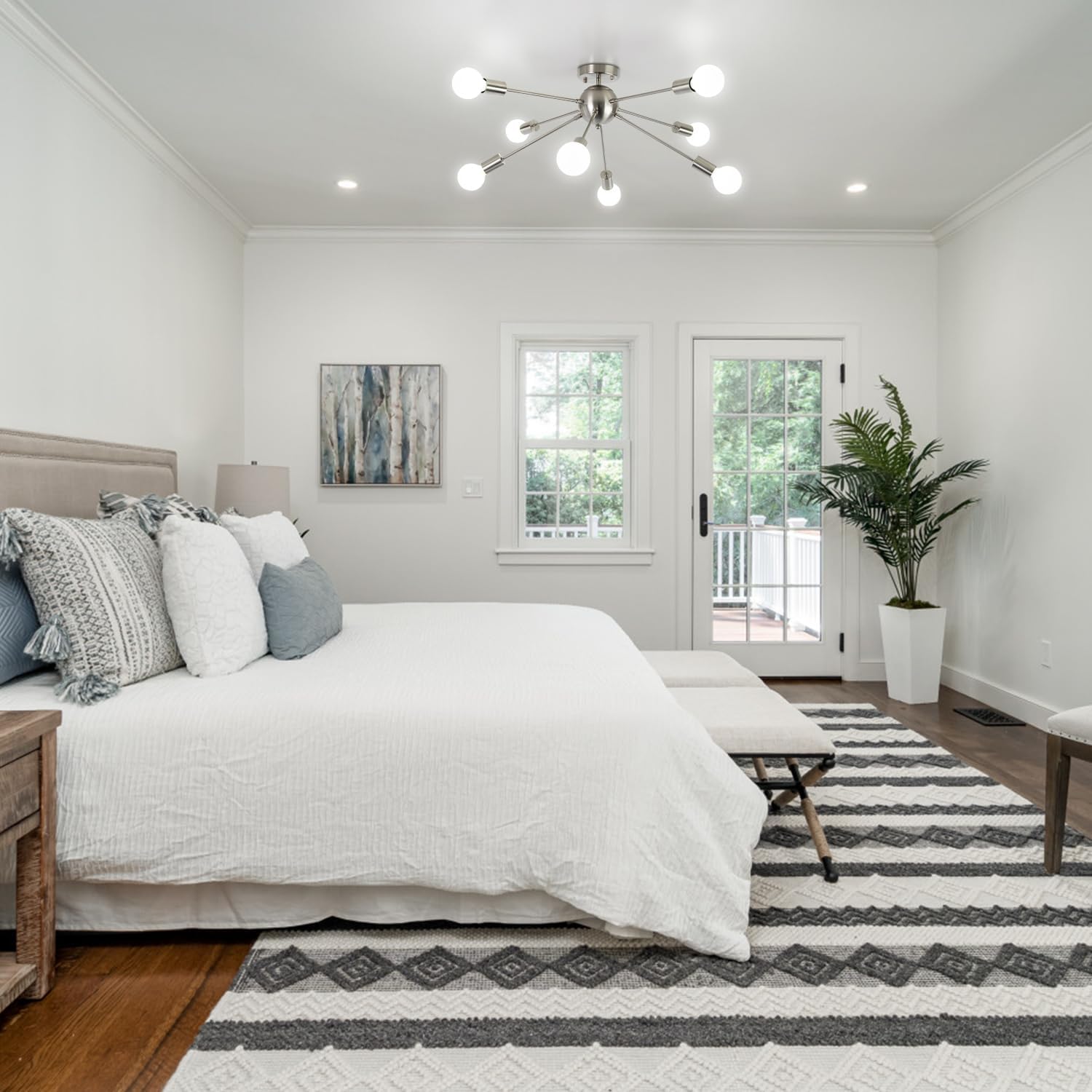 Modern bedroom with a bed, rug, and decorative elements.