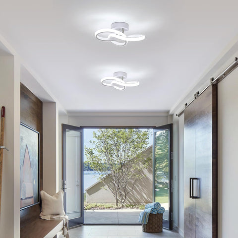 Modern interior with ceiling lights and a view of the outdoors through a glass door.