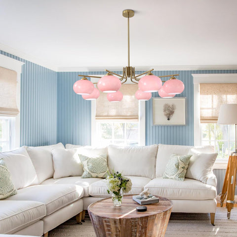 Living room with a white sectional sofa, pink pendant light, and striped walls.