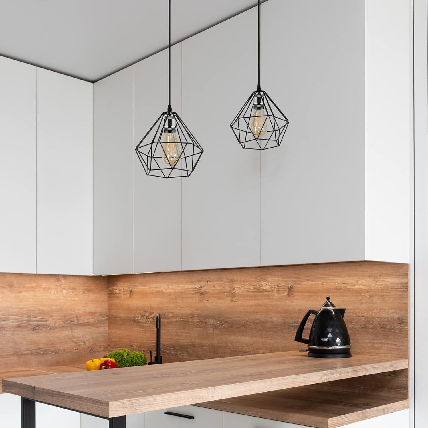 Modern kitchen with wooden countertop, black kettle, and geometric pendant lights.