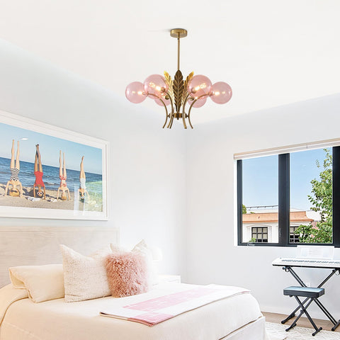 Modern living room with a chandelier, sofa, and wall art.