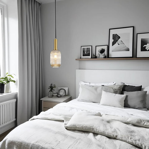 Modern bedroom with a bed, nightstand, and wall art.