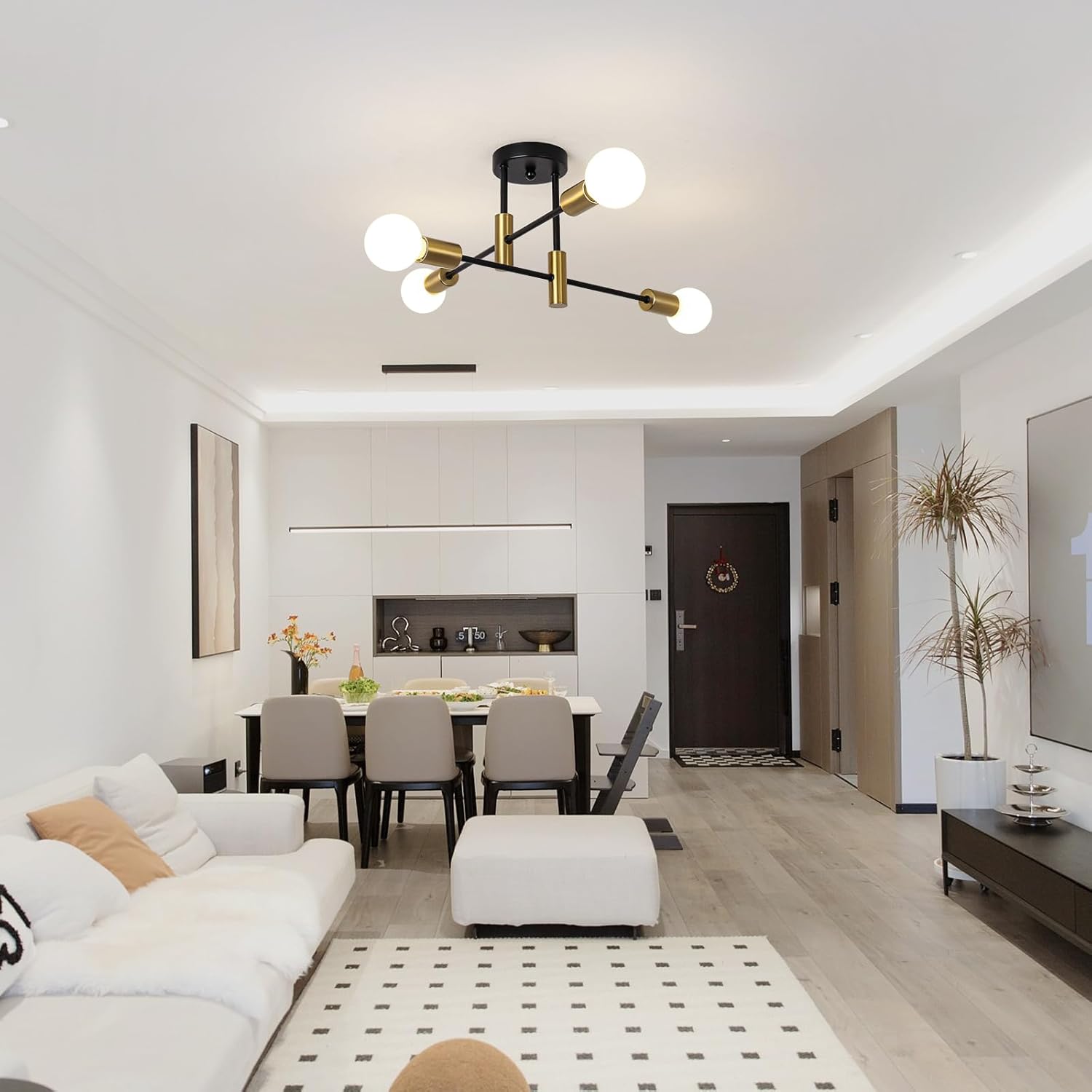 Modern living room with a chandelier, sofa, and dining table.